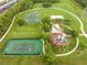 Aerial view of community park featuring tennis courts, basketball courts, volleyball, and playground areas at 2547 Raccoon Run Ln, Orlando, FL 32837