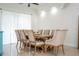 Bright dining room with a wooden table, upholstered chairs, and large windows providing ample natural light at 2547 Raccoon Run Ln, Orlando, FL 32837