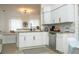 Stylish kitchen with white cabinets, granite counters, stainless steel appliances, and decorative accents at 2547 Raccoon Run Ln, Orlando, FL 32837
