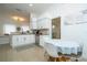 Well-lit kitchen with white cabinets, granite counters, stainless appliances, and a breakfast table at 2547 Raccoon Run Ln, Orlando, FL 32837