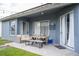 Inviting covered patio area with comfortable seating and a dining table perfect for outdoor relaxation at 2547 Raccoon Run Ln, Orlando, FL 32837