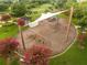 Aerial view of the playground featuring shade structures, climbing frames, swings, and seating at 2547 Raccoon Run Ln, Orlando, FL 32837