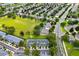 Aerial view of a community with well-maintained lawns, mature trees, and sidewalks at 2550 Renshaw St, Kissimmee, FL 34747
