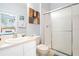 Clean bathroom featuring a vanity with sink and a walk-in shower with glass doors at 2550 Renshaw St, Kissimmee, FL 34747