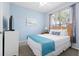 Cozy bedroom with a light-blue wall, a comfy queen bed and a bright window with blinds at 2550 Renshaw St, Kissimmee, FL 34747