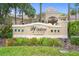 Windsor Hills Clubhouse entrance with a colorful flower bed and palm trees at 2550 Renshaw St, Kissimmee, FL 34747