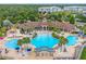 Aerial view of the community pool area, including a hot tub and ample lounge chairs at 2550 Renshaw St, Kissimmee, FL 34747