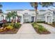 Charming townhouse with a well-maintained lawn and garden featuring palm trees and colorful shrubs at 2550 Renshaw St, Kissimmee, FL 34747