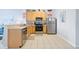 Well-lit kitchen with wood cabinets, stainless steel appliances and tiled floor at 2550 Renshaw St, Kissimmee, FL 34747