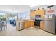 Efficient kitchen with wooden cabinets, stainless steel appliances, and open layout to the living area at 2550 Renshaw St, Kissimmee, FL 34747