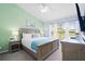 Well-lit main bedroom with a ceiling fan, ensuite bathroom, and a view of the golf course at 2550 Renshaw St, Kissimmee, FL 34747