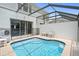 Private screened-in pool area with a safety fence at 2550 Renshaw St, Kissimmee, FL 34747