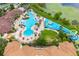 Aerial view of a community waterpark with slides, pools, and lush landscaping at 2550 Renshaw St, Kissimmee, FL 34747