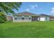 Expansive green backyard featuring a well-maintained lawn and a screened patio at 2663 Youngford St, Orlando, FL 32824