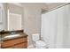 Bathroom with modern vanity, toilet, and shower with white curtain at 2663 Youngford St, Orlando, FL 32824