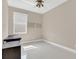 Bedroom with light walls, modern ceiling fan, and a window that allows for natural light at 2663 Youngford St, Orlando, FL 32824