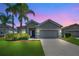 Charming single-story home with a well-manicured lawn and two palm trees in a quiet neighborhood at 2663 Youngford St, Orlando, FL 32824