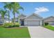 Charming single-story home with a well-manicured lawn and two palm trees in a quiet neighborhood at 2663 Youngford St, Orlando, FL 32824