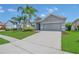 Well-maintained single-story home with lush landscaping and spacious driveway in a quiet community at 2663 Youngford St, Orlando, FL 32824