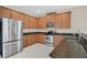Functional kitchen featuring wood cabinetry, stainless steel appliances, and ample counter space at 2663 Youngford St, Orlando, FL 32824