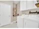 A well-lit laundry room with modern appliances and ample storage at 2663 Youngford St, Orlando, FL 32824