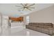 Spacious living room open to the kitchen, featuring tiled floors and a comfortable sofa at 2663 Youngford St, Orlando, FL 32824