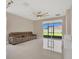 Open living area with tiled floors, a comfortable sofa, and a sliding glass door to the backyard at 2663 Youngford St, Orlando, FL 32824