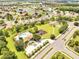 Community aerial view showcasing pool, clubhouse, playground, tennis, and basketball courts, landscaping at 2810 Maguire Dr, Kissimmee, FL 34741