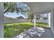 The backyard includes a lawn, a shade tree, and a white fence at 2810 Maguire Dr, Kissimmee, FL 34741