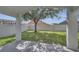 View of the fenced backyard with a shade tree from the lanai at 2810 Maguire Dr, Kissimmee, FL 34741