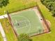 Aerial view of a basketball court showcasing the green playing surface, perimeter fence, and surrounding landscaping at 2810 Maguire Dr, Kissimmee, FL 34741