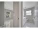 Bathroom featuring neutral paint, tile flooring, window, and doorway access to rooms at 2810 Maguire Dr, Kissimmee, FL 34741