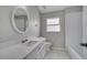 Neutral bathroom featuring tile floors, a vanity, and a tub with shower at 2810 Maguire Dr, Kissimmee, FL 34741