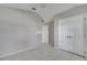 Neutral bedroom with tile floors, closet, ceiling fan, and access to bathroom at 2810 Maguire Dr, Kissimmee, FL 34741