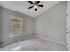 Cozy bedroom with neutral tones, a ceiling fan, and tile flooring at 2810 Maguire Dr, Kissimmee, FL 34741