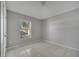 Bright bedroom featuring tile flooring, a large window, neutral paint, and ceiling fan at 2810 Maguire Dr, Kissimmee, FL 34741