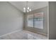 Dining room features a modern chandelier and large windows for natural light at 2810 Maguire Dr, Kissimmee, FL 34741
