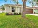 Charming home featuring a well-maintained lawn, two car garage, and mature trees at 2810 Maguire Dr, Kissimmee, FL 34741