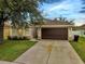Charming single-story home with a well-maintained lawn and a two-car garage at 2810 Maguire Dr, Kissimmee, FL 34741