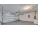 Spacious garage with an automatic door, painted walls and floor, and utility hookups at 2810 Maguire Dr, Kissimmee, FL 34741