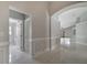 Hallway featuring tile floors, neutral paint and an arched doorway to a living space at 2810 Maguire Dr, Kissimmee, FL 34741