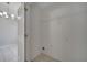 Bright laundry room boasts tile flooring, convenient shelf, and essential hookups for washer and dryer at 2810 Maguire Dr, Kissimmee, FL 34741