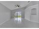 Cozy living area boasts tile flooring, ceiling fan, and sliding glass doors offering serene backyard views at 2810 Maguire Dr, Kissimmee, FL 34741