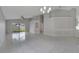 Spacious living room with tile floors, ceiling fan, and sliding glass doors to the backyard at 2810 Maguire Dr, Kissimmee, FL 34741