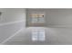Bright living room with neutral paint, tile floors, window, and ample natural light at 2810 Maguire Dr, Kissimmee, FL 34741