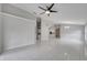 Expansive open-concept living area featuring modern lighting and tile flooring, seamlessly flowing into the kitchen at 2810 Maguire Dr, Kissimmee, FL 34741
