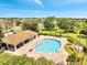 Aerial view of a community pool featuring a covered pavilion, lush landscaping, and various seating options at 2810 Maguire Dr, Kissimmee, FL 34741