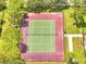 Aerial view of the community's fenced tennis court surrounded by mature trees and well-maintained landscaping at 2810 Maguire Dr, Kissimmee, FL 34741