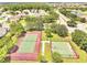 Aerial view of community amenities with tennis court and basketball court surrounded by lush landscaping at 2810 Maguire Dr, Kissimmee, FL 34741