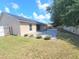Manicured backyard includes a concrete patio, privacy fence, and green space at 283 Pine Arbor Dr, Orlando, FL 32825